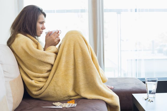 A sick woman sips a warm drink. Although vitamin C consumption won’t prevent people from getting a cold, people who do consume vitamin C regularly may find themselves with milder symptoms when they eventually get sick. ThinkStock