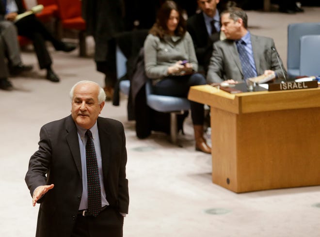 Palestinian Ambassador to the United Nations Riyad Mansour, left, goes to shake hands with members after a meeting of the U.N. Security Council on Tuesday at the United Nations headquarters. The U.N. vote Tuesday against the Palestinian bid, which called for the Israeli occupation to end within three years, was a blow to an Arab campaign for international action to bring about an independent Palestinian state.