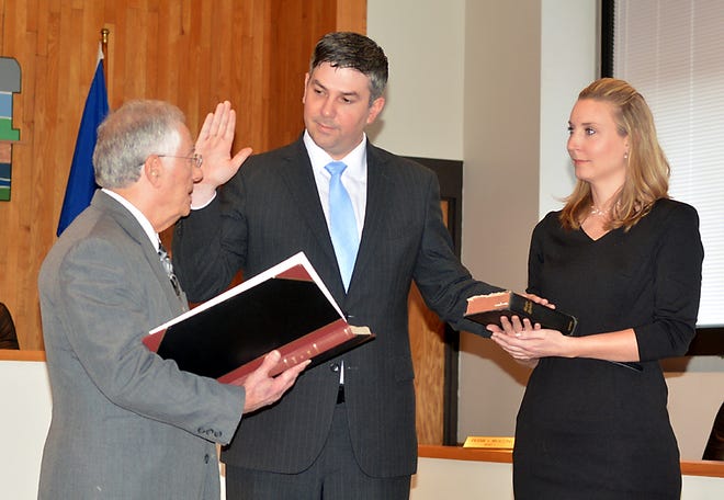 New Corning City Judge Mathew McCarthy gets sworn in by Corning Mayor Rich Negri as Jolie Riekofski holds the Bible during the ceremony. Eric Wensel/The Leader