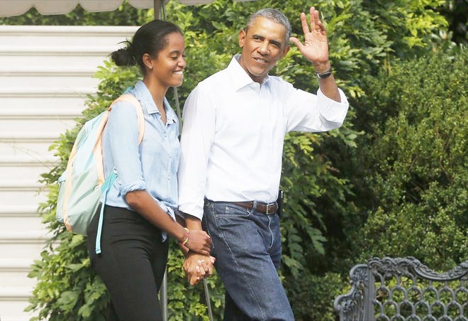 President Barack Obama waves to reporters as he walks with his daughter Malia on the South Lawn of the White House in Washington. Soon, Malia will choose where to apply for college and which one to attend in the fall of 2016.