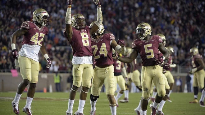 Florida State defensive back Jalen Ramsey (8), defensive back Lamarcus Brutus (42), linebacker Terrance Smith (24) and linebacker Reggie Northrup (5) react to a play during the second half of an NCAA college football game against Florida in Tallahassee, Fla., Saturday, Nov. 29, 2014. Florida State won 24-19.(AP Photo/Phelan M. Ebenhack)