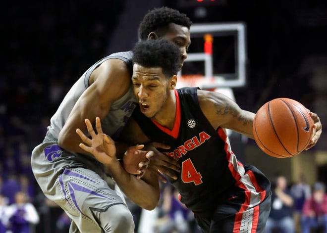 Georgia guard Charles Mann, right, is fouled by Kansas State guard Wesley Iwundu, left, during the first half of Wednesday's game in Manhattan. The Wildcats lost for the second time in a week at Bramlage Coliseum, 50-45.