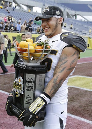 Missouri defensive lineman Shane Ray shows off the Citrus Bowl championship trophy.