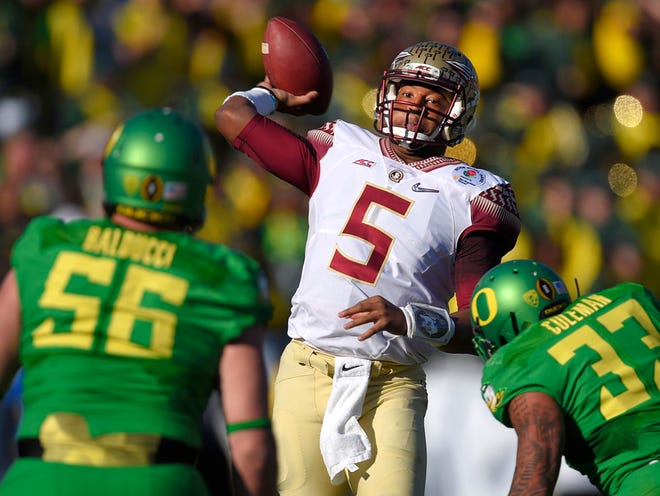 Florida State quarterback Jameis Winston, center, looks to pass under pressure by Oregon defensive lineman Alex Balducci, left, and Tyson Coleman during the first half of the Rose Bowl NCAA college football playoff semifinal, Thursday, Jan. 1, 2015, in Pasadena, Calif.