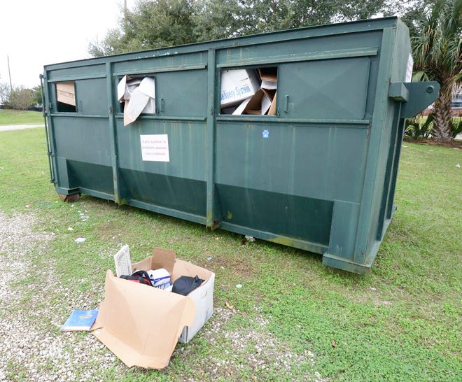 A container set up for holiday recycling at Lake Hartridge Nature Park in Winter Haven is full with items starting to accumulate on the ground.
