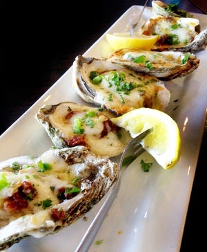 Chargrilled oysters on the half shell are offered at the new Harborside.