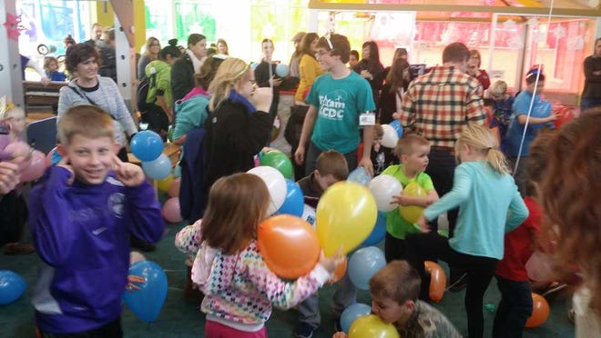 Some 400 children and their families participate in a "Noon Year's Eve" party Wednesday afternoon at the Kansas Children's Discovery Center. The event included the ceiling drop of some 900 balloons as the guests did an early, mid-day countdown to the New Year.