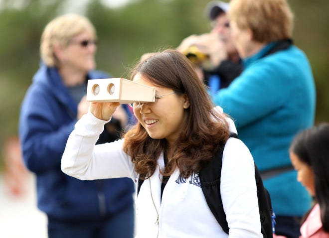 People participate in a bird walk as part of the First Day Hike at the Dudley Farm Historic State Park near Gainesville Jan. 1, 2015.