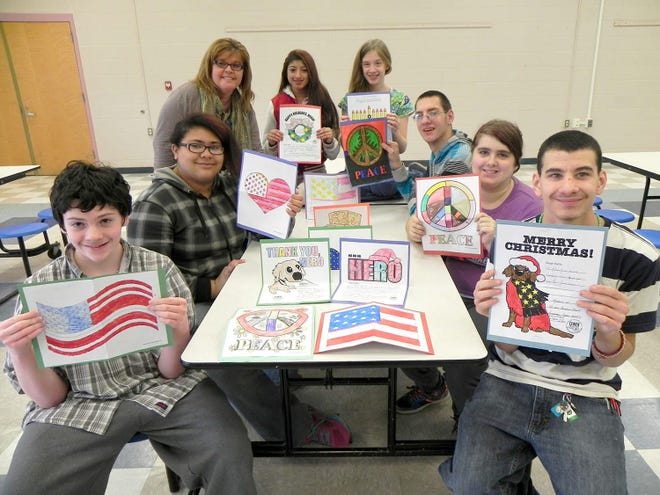 A few students at Sullivan BOCES show off their cards before they are sent to U.S. troops. From left: Luke Barile, Crystal Black, teacher Laura White-Henderson, Katherine Morales, Kristen Teller, Dominic McCombs, Courtney Hannold and Shane Van DeVeer. Photo provided