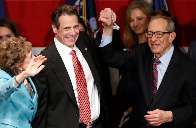 FILE - In this Nov. 4, 2014, file photo, Democratic New York Gov. Andrew Cuomo, second from left, celebrates with his father, former New York Gov. Mario Cuomo, and his mother, Matilda, left, after defeating Republican challenger Rob Astorino, at Democratic election headquarters in New York. Andrew Cuomo is the first New York Democratic governor since his father to win re-election. Cuomo died Thursday, Jan. 1, 2015, the day his son Andrew started his second term as governor, the New York governor's office confirmed. He was 82. (AP Photo/Kathy Willens, File)