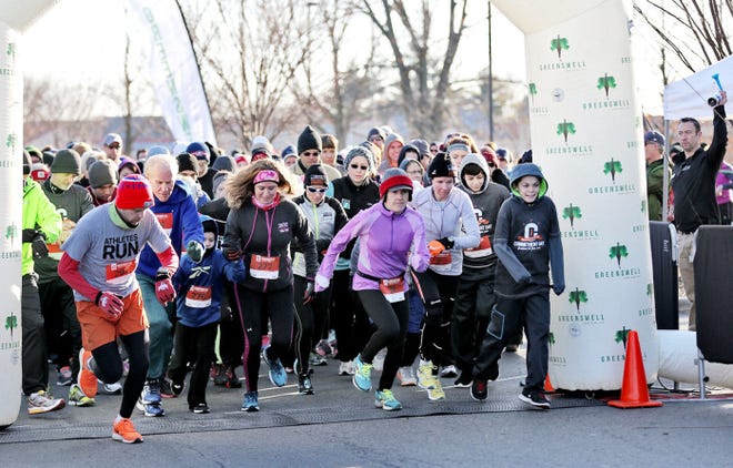 Ignoring the cold, runners break from the pack in the Commitment Day 5K at Life Time Fitness in Dublin.