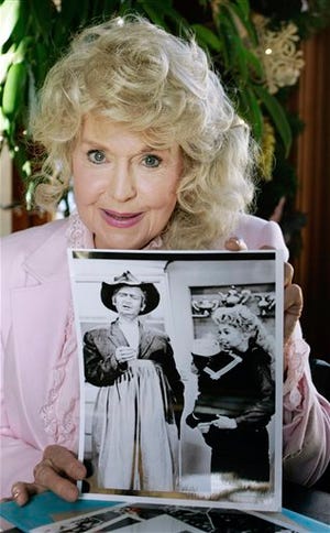 In this Jan. 8, 2009 file photo, Donna Douglas, who starred in the television series "The Beverly Hillbillies" holds a publicity picture of herself from the show.
