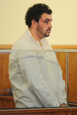 Jeffrey Souza, 24, stands in the courtroom during his arraignment Friday at Fall River District Court. Souza was arrested Thursday on gun-related charges in connection to a fatal shooting at Maplewood Park.