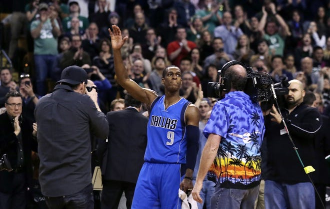 In his return to Boston, Mavericks guard Rajon Rondo waves to fans and photographers, after a video presentation on his career as a member of the Celtics, during a break after the first quarter of Friday's game. Charles Krupa/AP photo