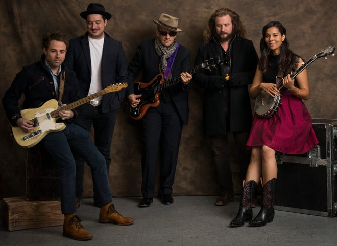Rhiannon Giddens poses with, from left, Taylor Goldsmith, Marcus Mumford, Elvis Costello and Jim James. (Drew Gurian/Invision/Associated Press)