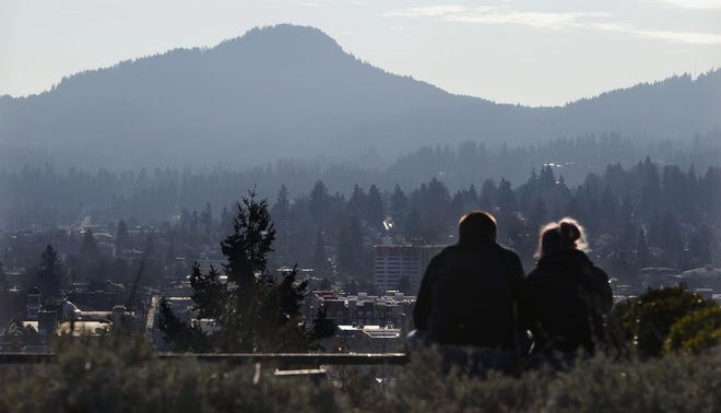 Visitors to Skinner Butte look out on a smoky city on Friday. (Andy Nelson/The Register-Guard)