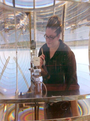 CONTRIBUTED Flagler College graduate Jessica Hadus interned with the St. Augustine Lighthouse and Museum during her final semester. Her work included restoration of the 140-year-old Fresnel lens at the top of the lighthouse. The lens, gears and motor were in need of cleaning and repair.