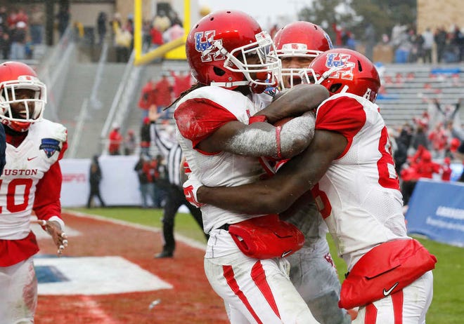 Houston wide receiver Deontay Greenberry (3) celebrates with wide receiver Steven Dunbar (88) after catching the game winning two-point conversion late in the second half of the Armed Forces Bowl NCAA college football game against Pittsburgh, Friday, Jan. 2, 2015, in Fort Worth, Texas. Houston won 35-34. (AP Photo/Sharon Ellman)