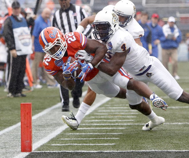 Florida Gators running back Adam Lane (22) is pushed out of bounds near the goal line by East Carolina Pirates defensive back Detric Allen (4) during the first half of the Birmingham Bowl at Legion Field on Saturday, Jan. 3, 2015 in Birmingham, Alabama.