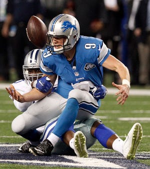 Dallas Cowboys defensive end Demarcus Lawrence (90) sacks Detroit Lions quarterback Matthew Stafford (9) cause a fumble during the second half of an NFL wildcard playoff football game, Sunday, Jan. 4, 2015, in Arlington, Texas. The Cowboys won 24-20.