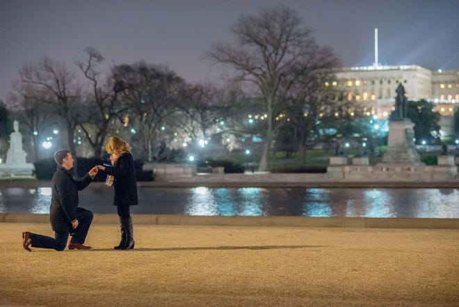 Jeff Ferraro, 32, proposes to Lauren Russo, 31, in front of the Capitol Christmas tree on Dec. 19. In recent years, couples have started hiring professional photographers to document proposals and other life events.