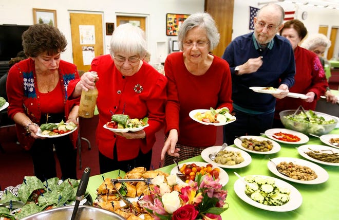 Braintree seniors recently celebrated graduation from a 12-week “Aging Mastery Program” which taught them how to live healthier and eat better. Above, graduates line up for healthy choices in a buffet provided by the culinary staff of Grove Manor.
