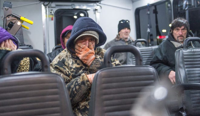 County homeless warm themselves aboard a bus from Advocates for the Homeless and Those In Need during the first Code Blue homeless round-up of 2015 as temperatures plummet in Bucks County, Monday January 5, 2015. Photo by Bryan Woolston / @woolstonphoto.