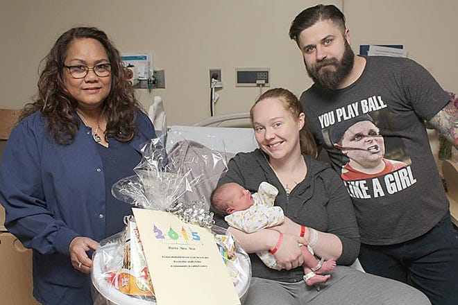 Rosemarie Amor-Salim, a registered nurse in the obstetrics department at the Community Health Center of Branch County, presents a basket of baby items prepared by the CHC auxiliary to Rebecca Stoy and Brenton Pfost, whose daughter Gwendolyn June was the first baby born at CHC in 2015. Gwendolyn arrived at 10:40 a.m. on Jan. 2.



Jamie Barrand photo