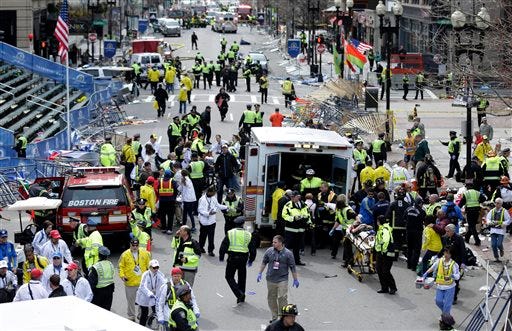 In this April 15, 2013, file photo, medical workers aid injured people at the finish line of the 2013 Boston Marathon following an explosion in Boston. Jury selection for bombing suspect Dzhokhar Tsarnaev's trial is scheduled to begin Monday, Jan. 5, 2015, in federal court in Boston.