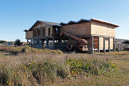 Construction workers renovate the bathhouse at Fort Macon State Park recently.