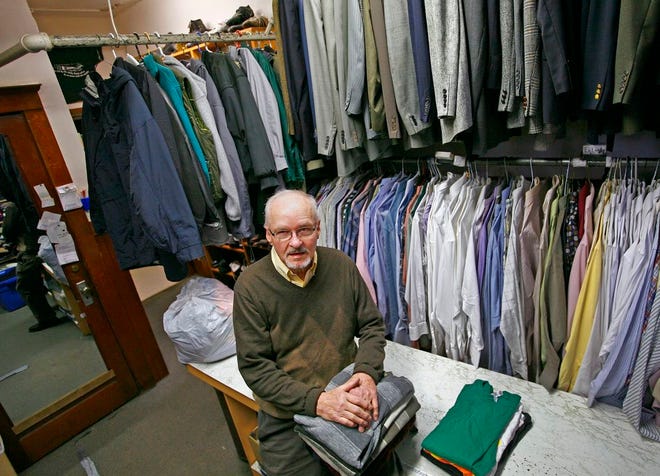 Bob Knowlton is surrounded by the clothing he has helped collect in the basement of the Fort Square Presbyterian Church in Quincy to be distributed to people in need.