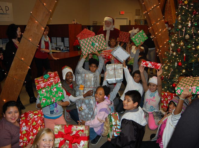 Students at one.TLC School for Homeless Children celebrate receiving their Christmas presents.