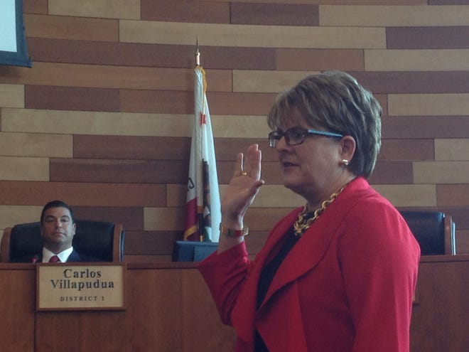 San Joaquin County Supervisor Kathy Miller is sworn into office on Monday as Supervisor Carlos Villapudua looks on. Soon after, the board elected Miller as its chairperson, bucking the rotation that would have placed Villapudua in that leadership role. ZACHARY K. JOHNSON/THE RECORD