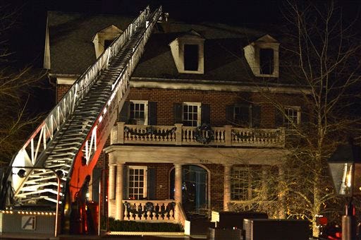 A ladder from a Charlotte Fire Department hook-and-ladder truck is shown outside a house owned by Carolina Panthers NFL football coach Ron Rivera in Charlotte, N.C., early Monday, Jan. 5, 2015. Rivera's house suffered fire, water and smoke damage in an early morning blaze but no one was injured, Charlotte Fire Department spokesman said. )