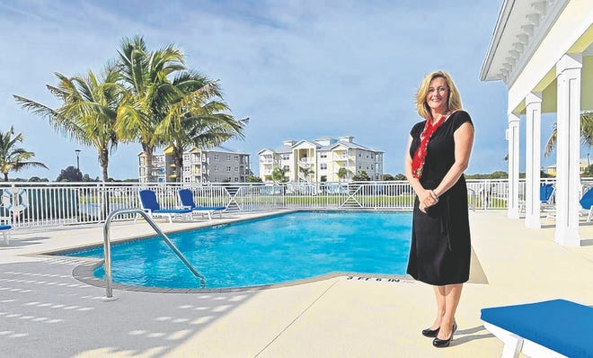 Debra Thomas, new-home sales associate at the upscale condo development 
Palma Sola Bay Club, in West Bradenton, says, "a lot of people seem to be 
warming to the idea that this will be the year they move down." STAFF PHOTO 
/ THOMAS BENDER