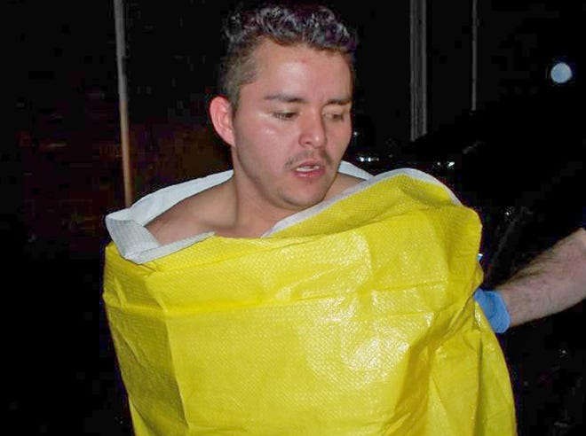 In this photo released by the Keizer, Ore., Police Department, 24-year-old Guillermo Brambila Lopez, of Woodburn, Ore., is wrapped in a blanket following his arrest.