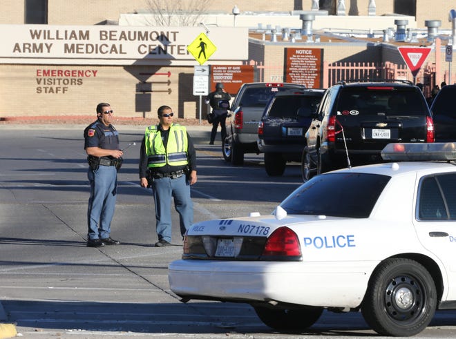 Police officers guard an entrance to the Beaumont Army Medical Center/El Paso VA campus during the search for a gunman Tuesday.