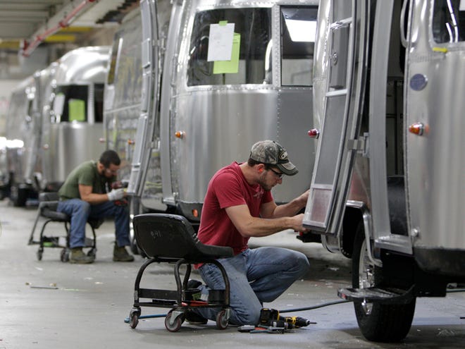 Jordan Peterson, of Bellefontaine, works on an Airstream travel trailer at the Airstream factory on Oct. 22 in Jackson Center, Ohio. The Commerce Department said Tuesday factory orders dropped 0.7 percent in November after a similar 0.7 percent fall in October.