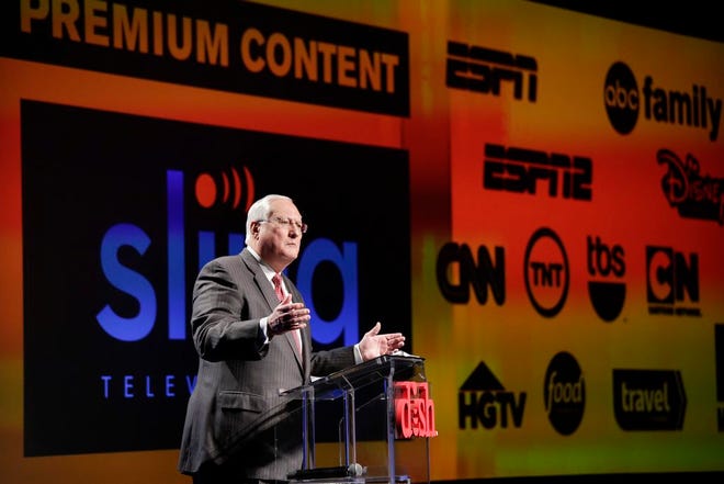 Joe Clayton, president and CEO of Dish Network, introduces the Sling TV, a live television streaming service, at a news conference at the International CES, Monday, Jan. 5, 2015, in Las Vegas. Standout features in many of the TV sets out this year will be more useful for streaming Internet video than watching broadcast or cable channels. In addition, satellite TV provider Dish Network Corp. will offer a package of channels, including ESPN and CNN, for delivery entirely over the Internet, starting at $20 a month. (AP Photo/Jae C. Hong)