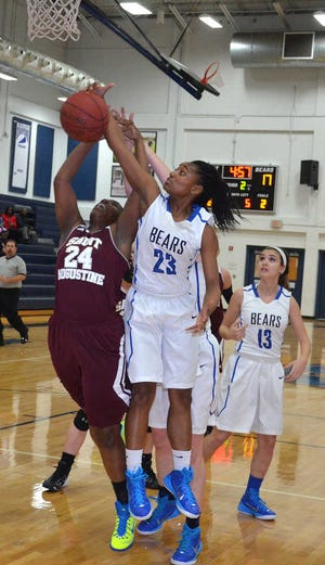 PETER.WILLOTT@STAUGUSTINE.COM St. Augustine High School's Eboni Daniels and Bartram Trail High School's Autumn Brown jump for a rebound in their game at Bartram on Tuesday, January 6, 2015.