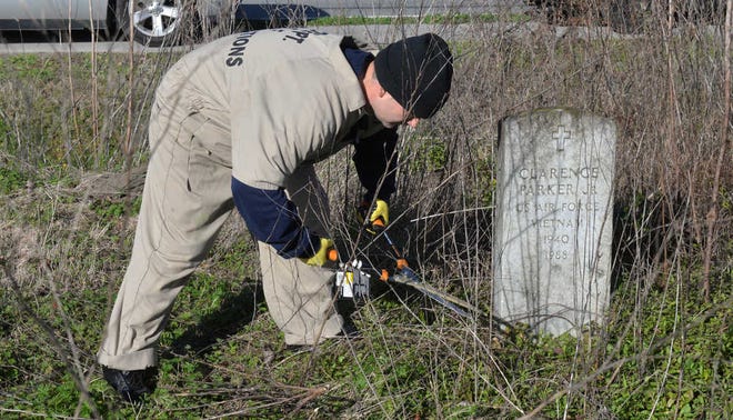 Steve Bisson/Savannah Morning NewsHerbert Maines with Dismas Charities clears weeds at Evergreen Cemetery.