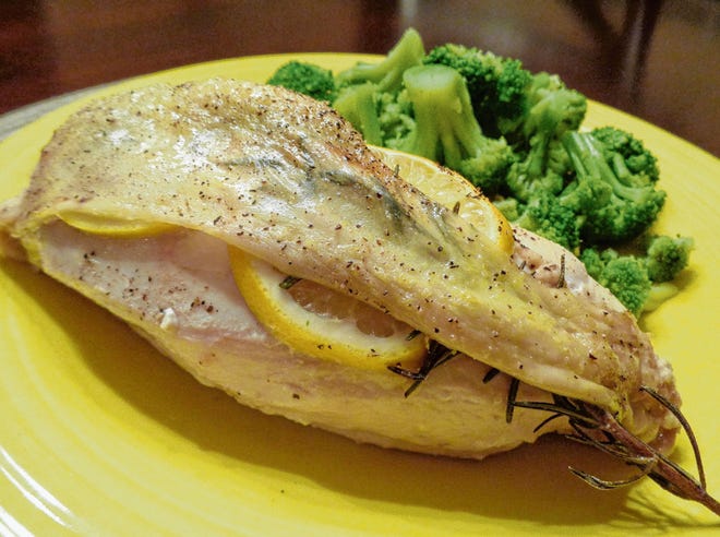 Chicken is served with steamed broccoli.