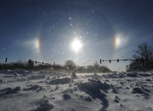 A cold weather phenomena called sun dogs appear in the sky over Ames Wednesday morning. Sun dogs are created by sunlight being refracted by ice crystals in the atmosphere. Ames residents woke up on Wednesday to a low temperature of minus 5 degrees and a windchill of minus 32 degrees. Photo by Nirmalendu Majumdar/Ames Tribune