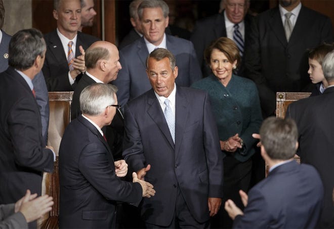 House Speaker John Boehner of Ohio is greeted by members of the House of Representatives at the opening session of the 114th Congress.