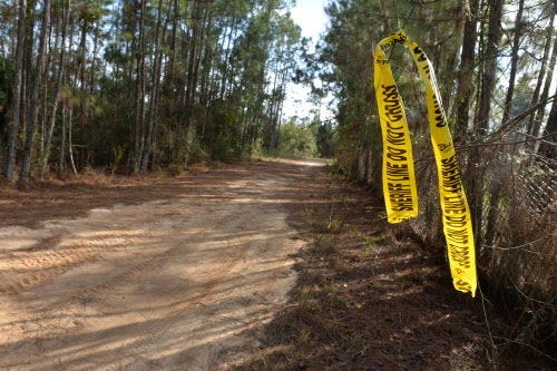 Crime scene tape hangs from an address marker in Groveland. The Lake County Sheriff’s Office is conducting an investigation after two men were found dead at a home.