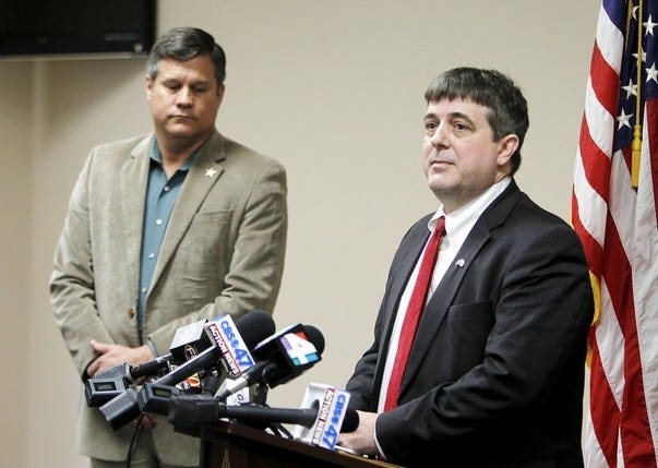 Columbia County State Attorney Jeff Seigmeister speaks during a press conference on Wednesday, Jan. 7, 2015 in Lake City, Fla. about two Columbia County girls accused of killing their brother. Columbia County Sheriff Mark Hunter, left, also spoke.