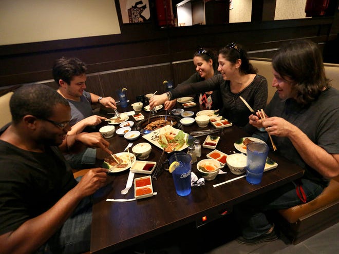 Friends enjoy their dinner at Shila Korean Barbecue in the Royal Park Plaza in Gainesville on Jan. 2.