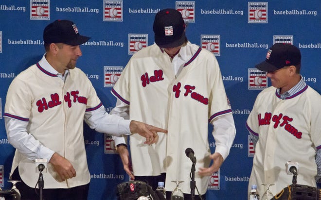 Hall of Fame dress code violation:                New baseball Hall of Famers John Smoltz, left, and Craig Biggio, right, react after noticing fellow inductee Randy Johnson's poorly buttoned jersey. In Johnson's defense, he had not put on a jersey since the 2009 season. Pedro Martinez also was inducted into the 2015 class.