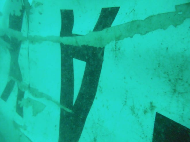 In this undated underwater photo released by Indonesia's National Search And Rescue Agency (BASARNAS) on Wednesday, Jan. 7, 2015, the part of the wreckage that BASARNAS identified as of the ill-fated AirAsia Flight 8501 is seen in the waters of the Java Sea, Indonesia. Divers and an unmanned underwater vehicle spotted the tail of the missing AirAsia plane in the Java Sea on Wednesday, the first confirmed sighting of any major wreckage 11 days after Flight 8501 disappeared with the passengers and crew members on board. (AP Photo/BASARNAS)