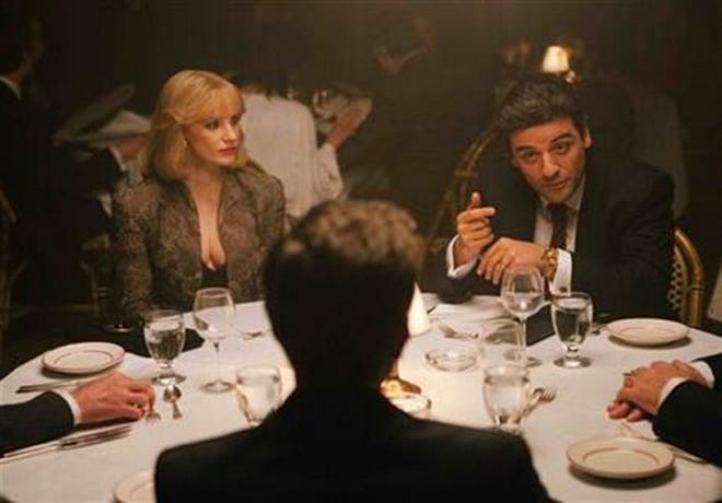 In this image released by courtesy of A24, Jessica Chastain, left, and Oscar Isaac appear in the film 'A Most Violent Year'.